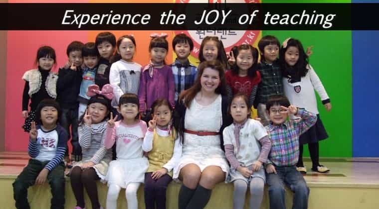 a TEFL teacher surrounded by smiling kindergarteners in Korea